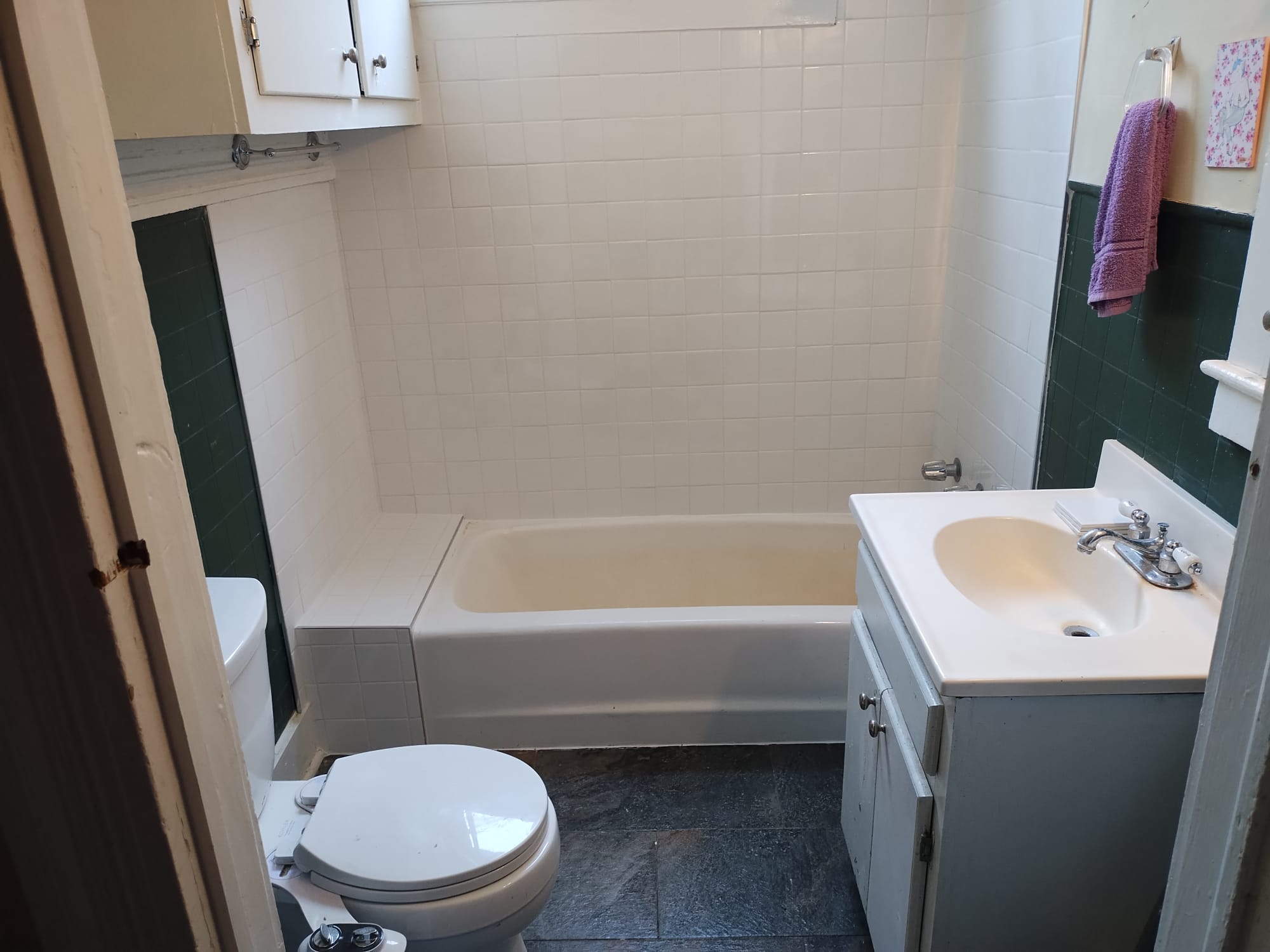 Compact bathroom with modern tub installation